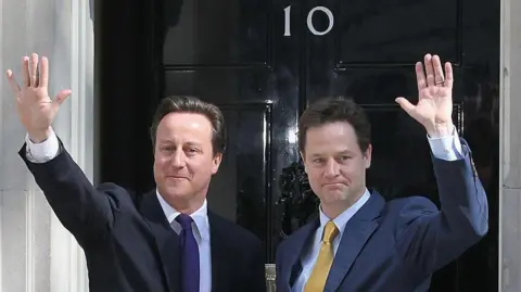 Getty Images David Cameron and Nick Clegg wave outside the door of 10 Downing Street.