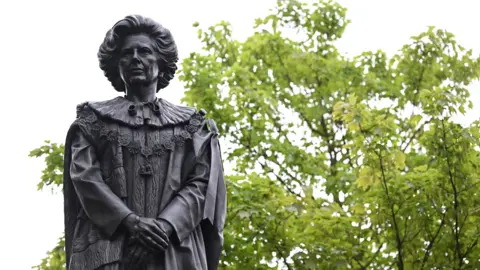 Getty Images A statue of Margaret Thatcher in Grantham against a backdrop of trees in leaf
