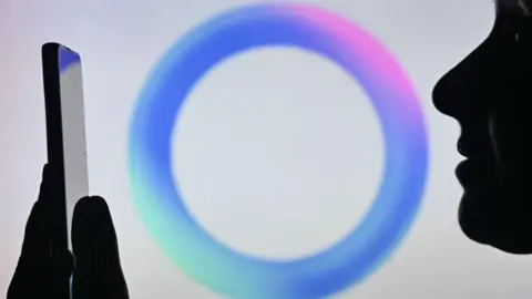 Getty Images A person looking at their phone. Behind them is the blue circle signifying Meta AI.