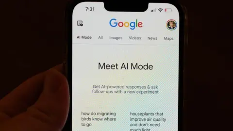 Getty Images A person holding a phone with Google