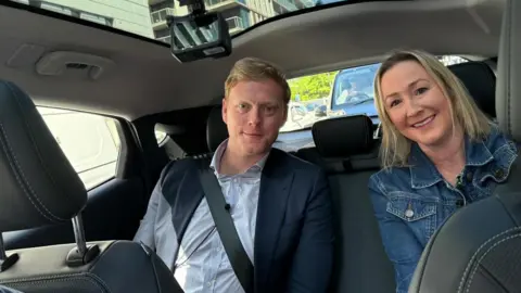 BBC Andrew MacDonald and Zoe Kleinman in the back seat of the taxi as it drives around London