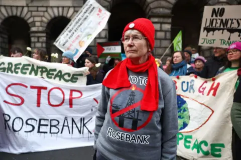 Getty Images Protesters outside Edinburgh's Court of Session with white banners saying 