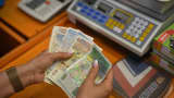 A worker counts Bulgarian Lev banknotes at a store in Sofia, Bulgaria, on Friday, March 29, 2024.