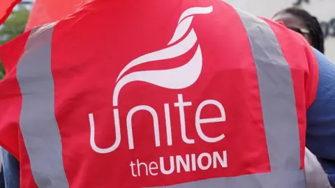 PA Media Man wearing Unite the Union red tabard