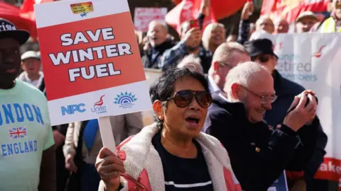Getty Images A woman holding a placard reading: