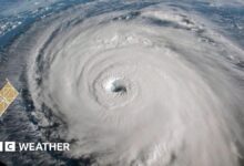 photo of a swirl of white, with an eye in the middle, showing hurricane Florence from space