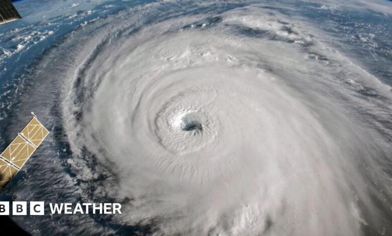 photo of a swirl of white, with an eye in the middle, showing hurricane Florence from space