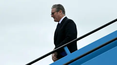 PA Media Sir Keir Starmer gets off a plane in Amsterdam, ahead of a Nato summit