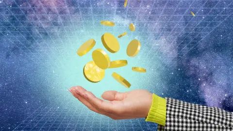 Getty Images Gold coins shown falling into someone's outstretched hand.
