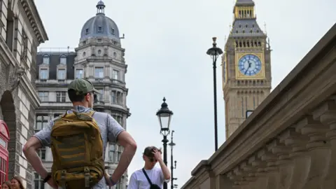 Getty Images Two men pictured near the Palace of Westminster, in London