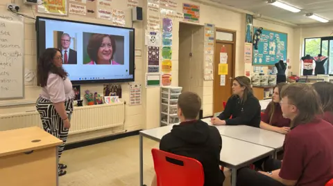 BBC Students at Birchgrove Comprhehensive looking at pictures of Keir Starmer and Eluned Morgan