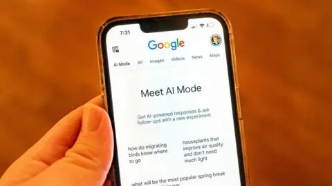 Getty Images A hand holding a mobile phone. On the screen is displayed Google across the top and then in the centre 