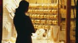A woman looks at the jewelry displayed at a jewelry shop.