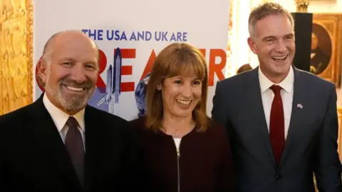 Reuters (L-R) US Commerce Secretary Howard Lutnick, UK Chancellor Rachel Reeves and Business Secretary Peter Kyle appear at a reception in London
